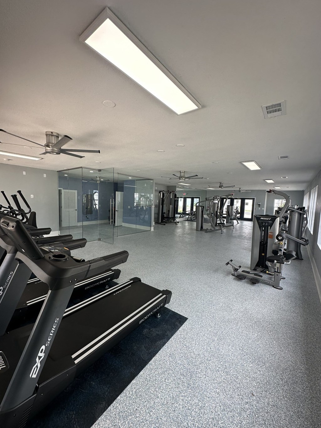 a gym with treadmills and other exercise equipment in a building